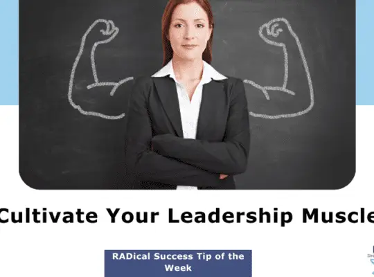 Confident businesswoman with folded arms standing in front of a chalkboard with muscle arms drawn behind her, symbolizing the cultivation of leadership strength.